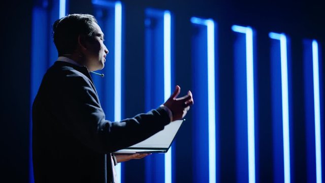 Business Conference Stage: Indian Tech Guru, Startup CEO Presents New Product, Holding Laptop, Does Motivational Talk, and Lecture about Science, Technology, Entrepreneurship, Development, Leadership 