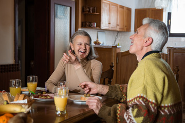 Happy senior couple heaving breakfast