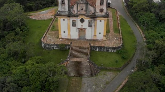 Aerial approach showing the location and detail and finally the stairs leading to the old Saint Francis of Paola church on a hilltop in colonial mining city Ouro Preto, Minas Gerais, Brazil