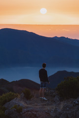 Fototapeta premium Man on top of Pico Ruivo, Madeira.