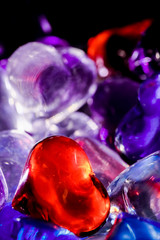 Heart of multi-colored glass hearts on an old wooden background. Romantic background. Valentine's day concept, anniversary, wedding. glowing crystals. glare, bokeh.