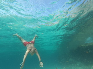   underwater man snorkeling in the sea with crystal-clear waters concept of holiday relax summer beach diver in the sea