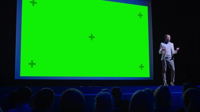 Business Conference Stage: Keynote Speaker Presents New Product to the Audience, Movie Theater Shows Green Screen, Mock-up, Chroma Key. Live Event on Health and Technology Development Topics