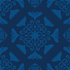 Vector seamless pattern modern abstract floral tile design. Hand drawn elements with a slight folk art flair in a monochromatic classic blue color palette.