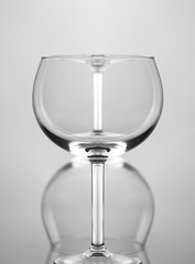 Wine Glass Abstract: Two wine glasses one in front of the other and upside down, against a gray background.