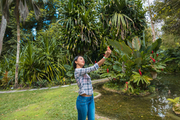 Woman capturing a self-portrait with her cell phone in the park