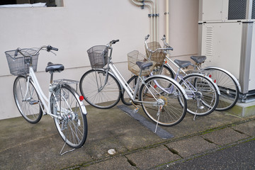 Naklejka na ściany i meble three bicycles parking at side walk