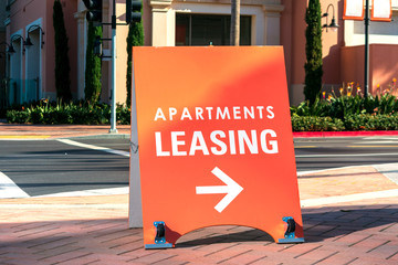 Apartments leasing sign promotes the rental property and shows direction where the rental office is...
