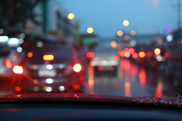traffic jam on night road city with storm rainy day weather, car driving on street town with water...