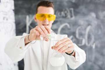 Chemist carries chemistry experiment in laboratory. Test-tubes with chemical reagent. Chemical...