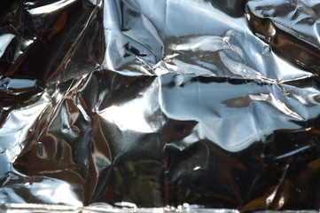 The abstract of the silver paper surface that reflects sunlight