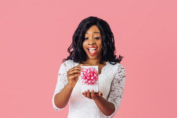 Portrait of  young happy woman having a positive reaction while opening a birthday, anniversary or...