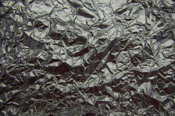 texture of rumpled silver foil close-up top view
