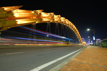 Fototapeta premium DANANG, VIETNAM - APRIL 19, 2019 - Dragon bridge at night, the famous bridge in Da Nang city, Dragon Bridge can be breath fire and water in weekend.
