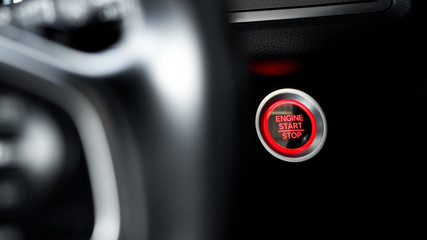 Obraz premium Close up modern car engine start stop button on black leather car console and copy space