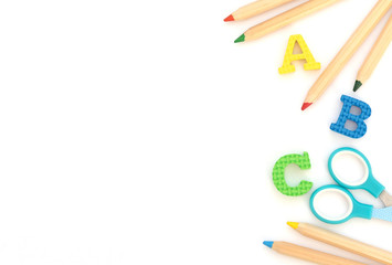 Soft English letters with school and office supplies on white background. Back to school, stationary concept. Kid's set for teaching reading and writing. Flat lay style, top view with copy space.