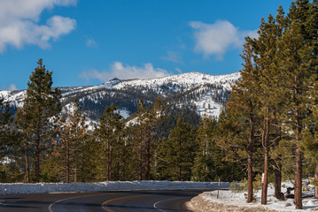 Fototapeta na wymiar Landscape of road, trees and snow-covered mountains on the Mount Rose Summit highway at Incline Village, Nevada