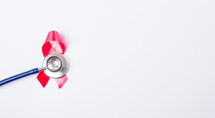 Breast cancer month concept, flat lay top view, pink ribbon and stethoscope