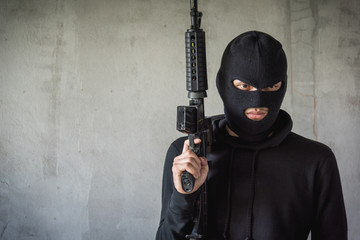 Portrait robbery man standing is holding M16 gun on hand