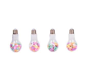 Conversation hearts in a light bulb container