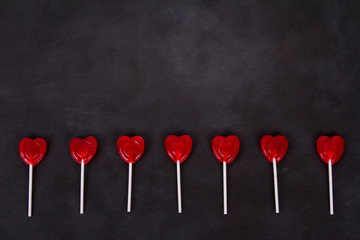 Heart shaped lollipops on a chalkboard