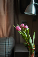 Flowers tulips in the vase in minimalism interior flat