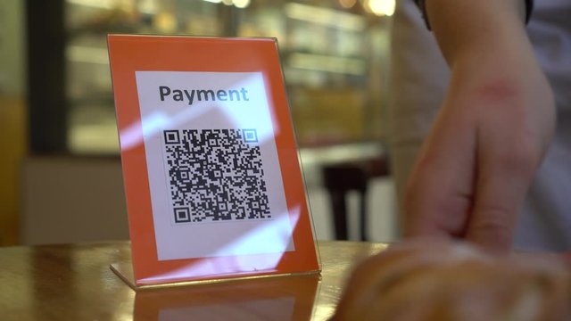 Qr code payment display in the cafe. To pay the product or a service, customer have to scan the QR code and confirm the payment
