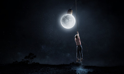 Kid boy catching moon. Mixed media - obrazy, fototapety, plakaty
