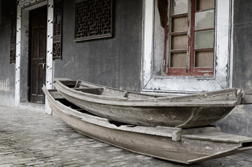 Fototapeta na wymiar Ancient boathouse and abandoned boats at Shanghai Pudong Lingkong Gardens China