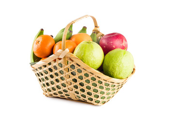 orange, guava, banana and apple in wicker basket on white background fruit health food isolated