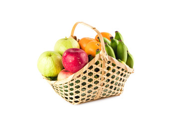 orange, green guava, banana and red apple in bamboo wicker basket on white background fruit health food isolated