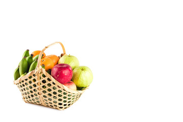 madarin orange, guava fruit, banana and red apple in gift basket on white background fruit health food isolated
