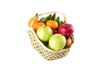 orange, guava, banana and apple in wicker basket on white background fruit health food isolated