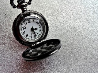 Old pendant watch on a silver background.Pocket watch.