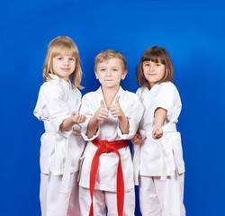 Two girls and a boy are showing thumbs super and fists © andreyfire
