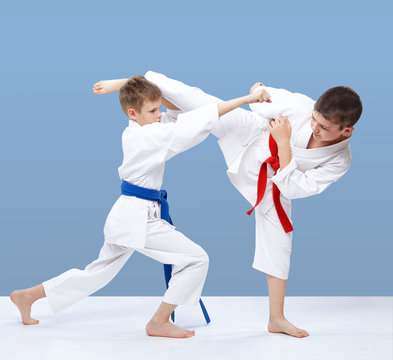 With red and blue belt karate athletes beat blows