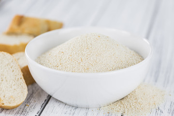 Vintage wooden table with Bread Crumbs (selective focus; close-up shot)