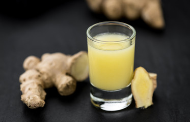 Some fresh Ginger Drink (selective focus; close-up shot)