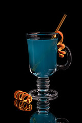 Blue cocktail, carbonated refreshing drink. Blue lagoon on a black background
