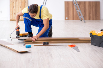 Young male contractor working indoors