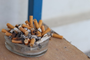 Cigarette buds accumulated on small ash tray  