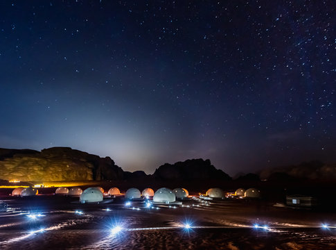Stars above martian dome tents in Wadi Rum Desert, Jordan.