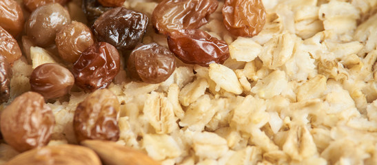 Oatmeal breakfast bowl. Organic healthy food with candied fruit raisins, nuts