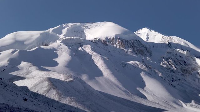 panoramic view of thorung la pass covered by snow during a sunny day himalayan mountains nepal, famous pass at five thousand meters