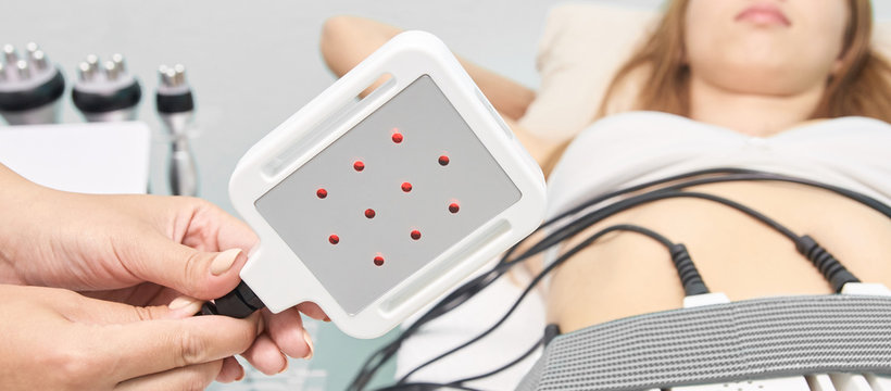 Laser lipo equipment. Cosmetic fat reduce treatment. Woman in medicine salon. Anti cellulite procedure