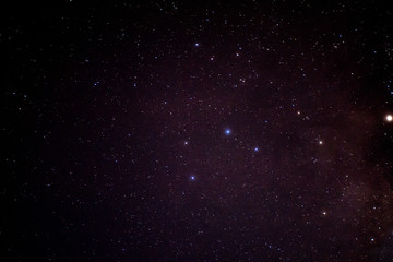 Beautiful night sky and many stars. Long exposure photograph with grain.