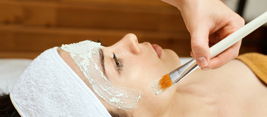 chemic facial peel mask. Cosmetology acne treatment. Young girl at medical spa salon. Brush. Face...