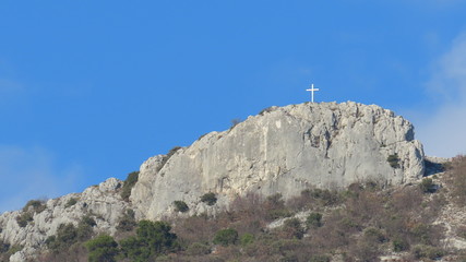 Mountain in Croatia Trogir with blue heaven and a cross