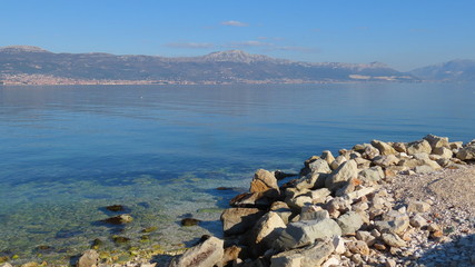 Fototapeta na wymiar Adria sea with stones and blue sky in Croatia