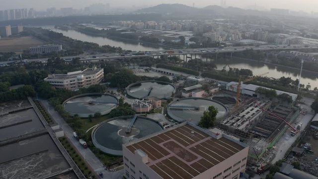 Aerial view of water  treatment plant near a highway with dense traffic on the sunset in Guangzhou, China